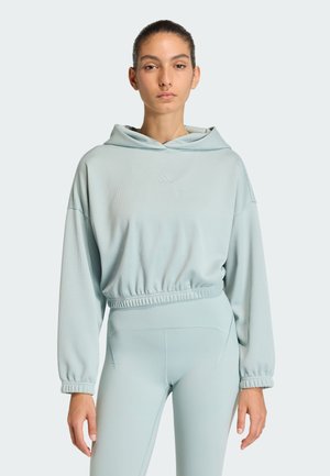 Relaxed-fit, light blue hooded sweatshirt with a textured pattern, elastic waistband, and long sleeves, paired with matching light blue leggings.