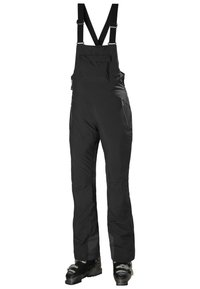 Pantalones de peto impermeables negros con tirantes ajustables, bolsillos con cremallera y piernas inferiores reforzadas, diseñados para actividades en climas fríos.