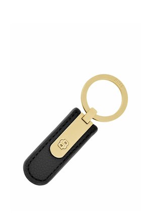 Zwarte leren sleutelhanger met gouden metalen ring en sluiting, met een reliëflogo op de sluiting en de merknaam gegraveerd op de ring.