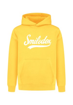 Gelber Kapuzenpullover aus Baumwollmischgewebe. Verfügt über eine Kängurutasche und gerippte Bündchen. "Smilodox"-Logo in Weiß auf der Vorderseite aufgedruckt.