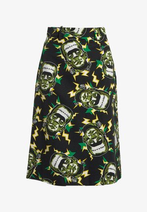 Jupe noire avec des éclairs verts et jaunes et un motif répétitif de visages de monstre de Frankenstein verts.