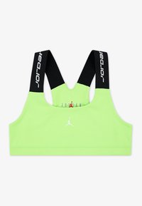 Neon zaļa sporta krūšturis ar melniem siksniņām. Priekšpusē ir balts Jumpman logo un uz siksniņām teksts "Jordan". Gluda tekstūra.