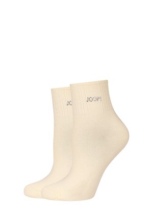 Paar cremefarbener Knöchelsocken mit gerippten Bündchen und dem "JOOP!"-Logo, das nahe dem oberen Rand eingestickt ist.