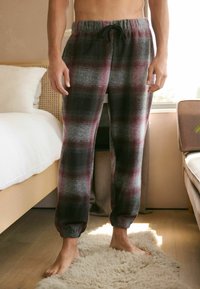 Šedé a burgundské kostkované pohodlné kalhoty z měkké látky s elastickým pasem na šňůrku a zúženými manžetami.