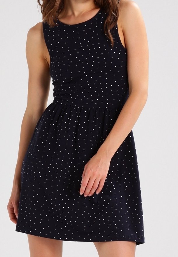 Robe sans manches marine avec des pois blancs, corsage ajusté et jupe évasée. Tissu lisse avec un col rond et une taille froncée.