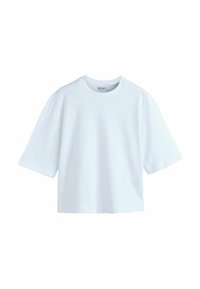 T-shirt court blanc uni à manches courtes avec col rond et coupe décontractée, présenté sur un fond blanc.