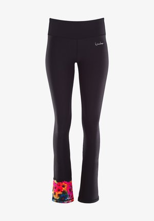 Zwarte leggings met een brede tailleband en een bloemenmotiefaccent aan de onderrand in felle kleuren, gemaakt van rekbare, gladde stof.