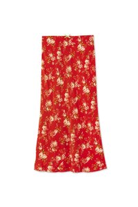 Red fabric skirt featuring a floral pattern with white and pink roses, green accents, and a smooth texture. A small green bow is at the top.