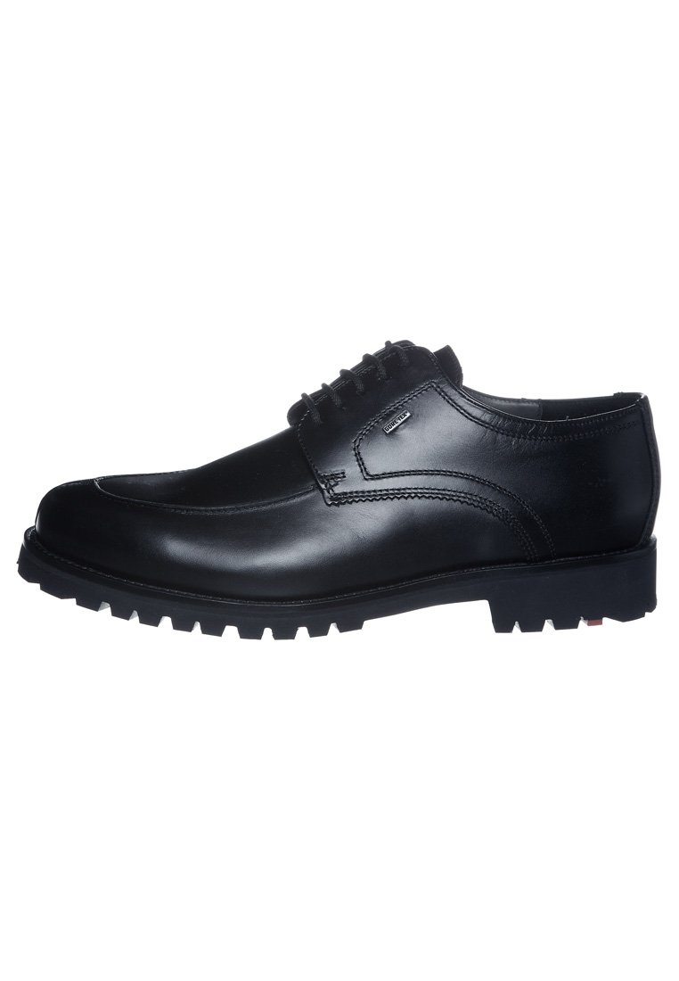 Chaussures en cuir noir avec un bout arrondi, présentant des accents de couture, six paires d'œillets pour les lacets, et une semelle en caoutchouc robuste.