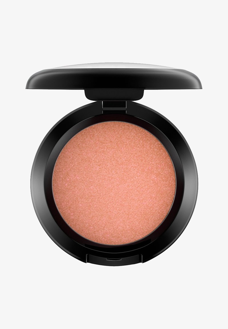 Blush compacto de forma redonda, con un polvo suave y sedoso en tono rosa melocotón y un estuche de plástico negro brillante con tapa plegable.