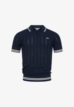 Granatowa krótka dzianinowa koszulka polo z białymi paskowanymi kołnierzem, mankietami i dołem, z małym logo „EST. 1992” na lewej piersi.