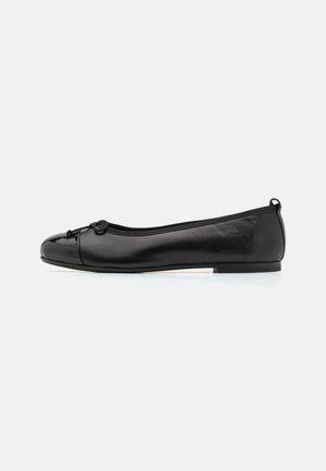 Black patent leather ballet flat with a rounded toe, featuring a small bow detail at the front and a cushioned insole for comfort.