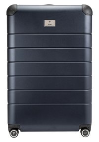 Valise rigide marine avec des rainures verticales, des protecteurs d'angle en caoutchouc, quatre roues noires et un logo argenté à l'avant.