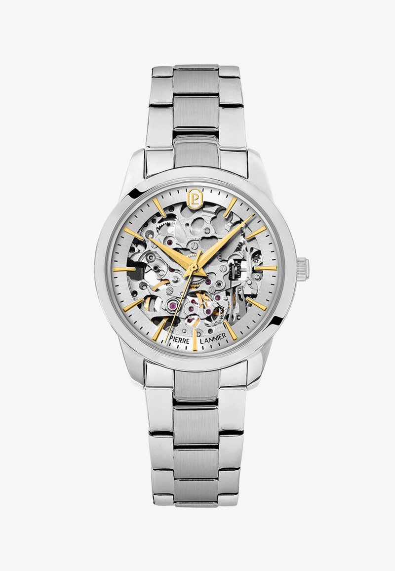 Stříbrné kovové náramkové hodinky s odkrytým vnitřním soukolím, zlatými hodinovými značkami a ručičkami a kovovým páskem s články.