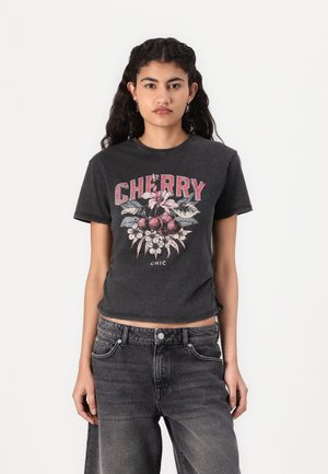 Black cotton t-shirt with short sleeves featuring a cherry and floral graphic in pink and white. Cropped design, slightly distressed edges.