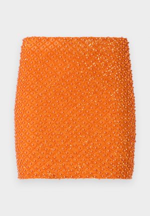 Orange mini skirt with a textured surface, featuring a diamond pattern embellished with shiny circular beads throughout.