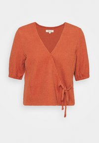 Rostorange omlottopp med korta puffärmar, texturerad tyg, djup V-ringning och en knytning vid midjan.