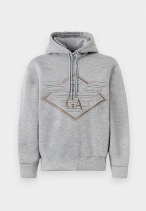 Gray hoodie made of soft fabric, featuring a diamond logo with wings and embroidered "GA" in brown. It has a drawstring hood and ribbed cuffs.