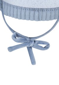 Light blue fabric drawstring tied in a bow with visible stitching and gathered elastic waistband above the knot.