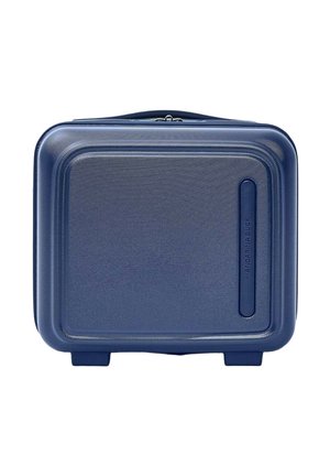 Valise rigide compacte bleu marine avec coins arrondis et surface texturée, posée debout sur deux petits pieds.