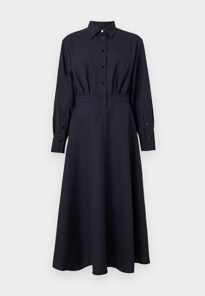 Sötétkék ingruha sima anyagból, hegyes gallérral, gombos elülső résszel, hosszú ujjak gombos mandzsettákkal és bővülő szoknyával.