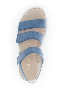 Blauwe sandalen van denimachtige stof met drie brede banden en een gesloten hiel, met een beige voetbed en gouden branding op de binnenzool.