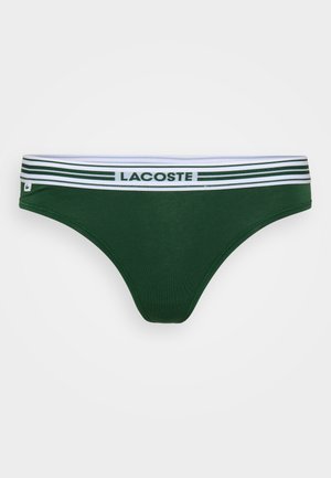 Roheline puuvillane bikiini aluspüksid, millel on valge ja roheline triibuline elastne vöökoht ning "LACOSTE" logo. Sile tekstuur ja sobiv kuju.