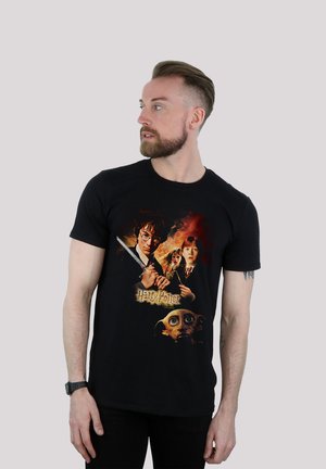 Black t-shirt featuring a colorful graphic print of characters from "Harry Potter," including a wand and a house-elf detail. Short sleeves.