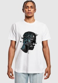 White cotton t-shirt featuring a graphic design of a profile with dark colors, fragmented textures, and butterfly accents in blue and black.