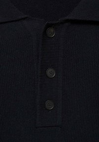 Navy knit polo shirt featuring a folded collar and four black plastic buttons down the front. Textured fabric adds depth to the design.