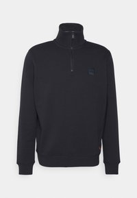 Svart fleece-quarters-zip-tröja med hög krage, med en liten svart logotyppatch på bröstet och ribbade mudd och nederkant.