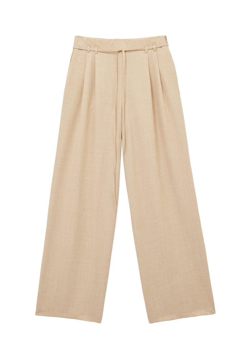 Pantalons larges beige en tissu texturé. Dotés d'une taille à cordon de serrage et de plis à l'avant. Ourlet plat, coupe décontractée.