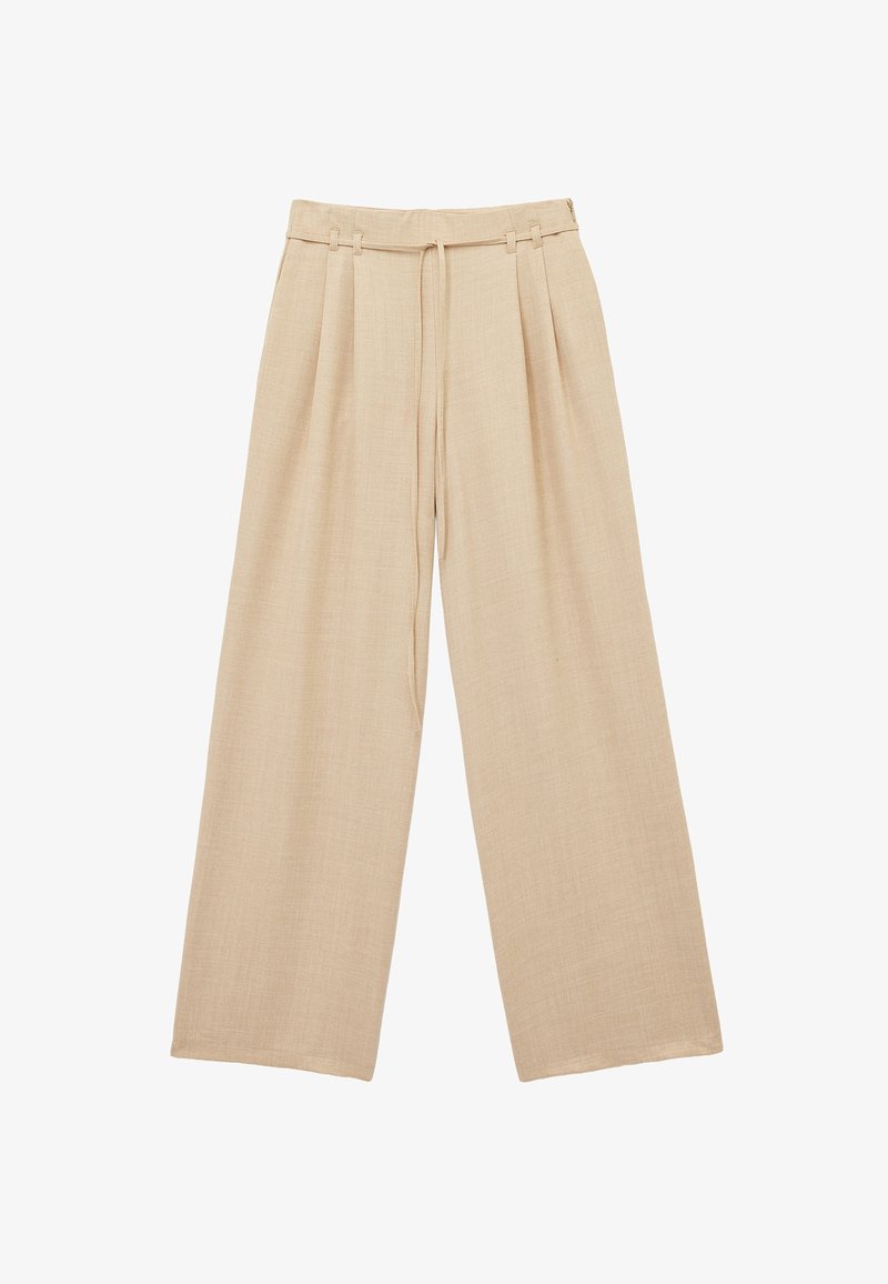 Pantalons larges beige en tissu texturé. Dotés d'une taille à cordon de serrage et de plis à l'avant. Ourlet plat, coupe décontractée.