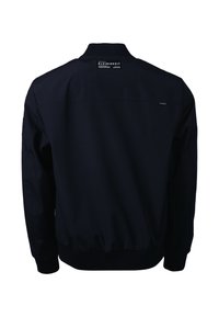 Veste noire vue de dos avec col, poignets et ourlet côtelés, et patch d'étiquette "KLEINIGKEIT" sous la nuque.