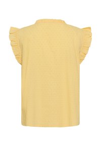 Blouse jaune sans manches avec emmanchures à volants et motif vertical de points texturés, vue de dos sur fond blanc.