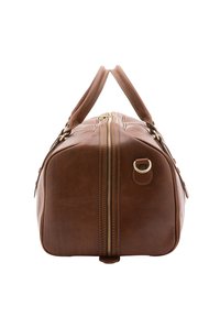 Sac de voyage en cuir marron de forme rectangulaire, avec deux poignées, une fermeture éclair et des coutures visibles le long des bords. Accents métalliques notables.