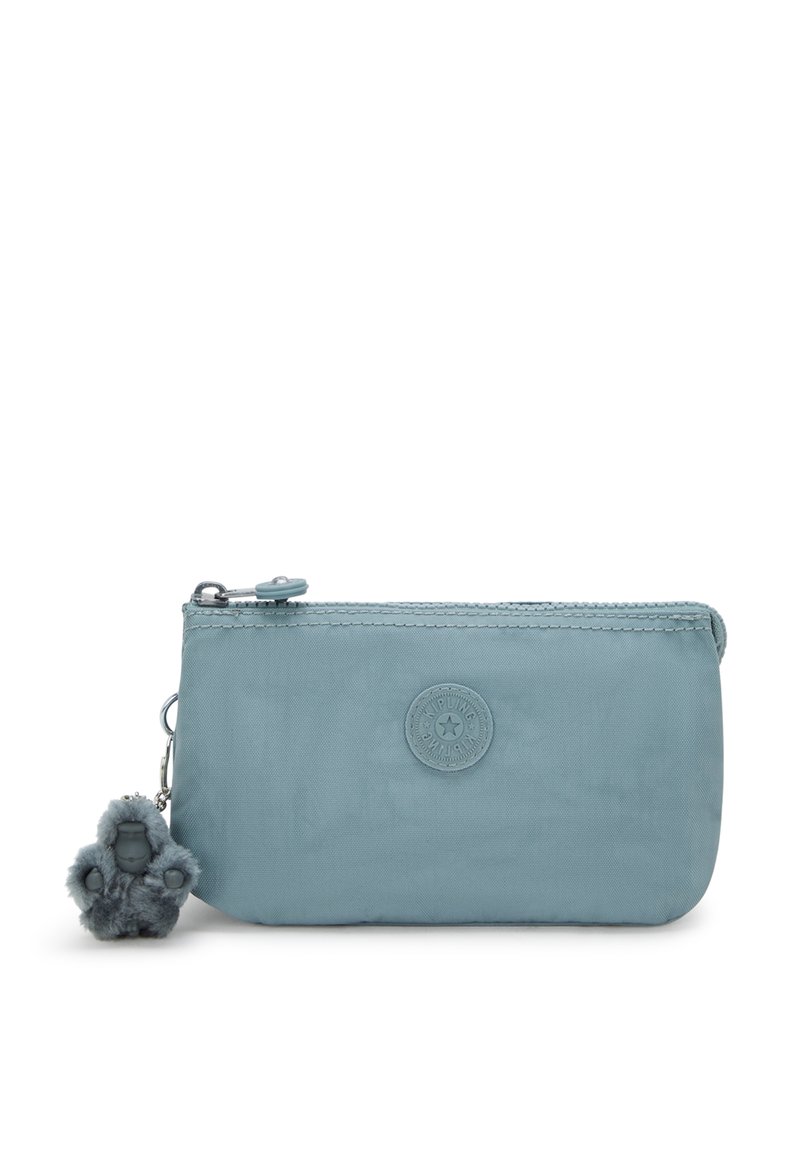 Light blue nylon pouch with zip closure, circular logo detail, and a furry gorilla charm attached. Compact and smooth texture.