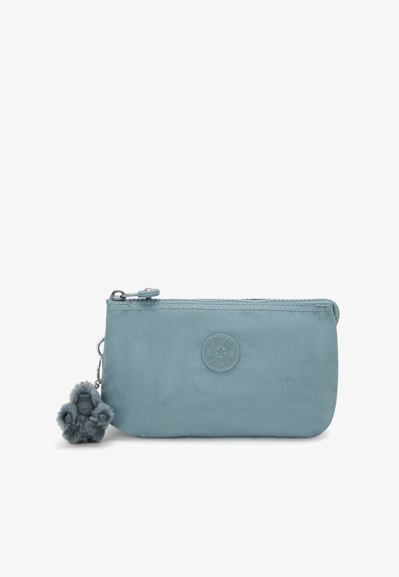 Light blue nylon pouch with zip closure, circular logo detail, and a furry gorilla charm attached. Compact and smooth texture.
