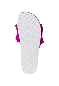 White sole with wavy tread pattern on a pink sandal with a bow, viewed from the bottom on a white background.