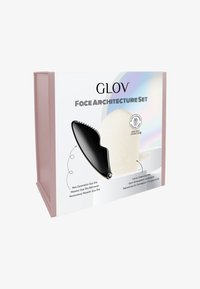 Black Gua Sha tool alongside a white cleansing mitt, packaged in a pink box with sleek, modern design and glossy accents. All elements labeled.