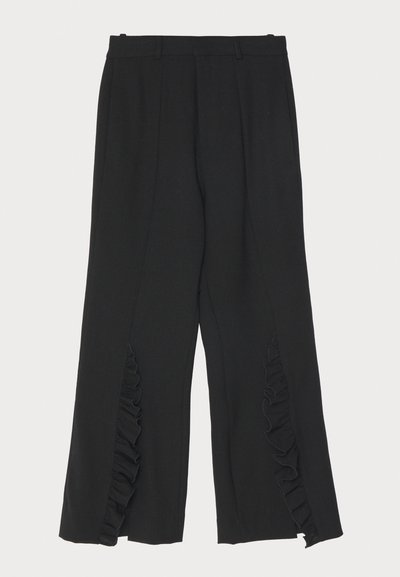 Black trousers with a wide-leg design, featuring ruffle accents at the side seams and a flat waistband. Smooth fabric texture, tailored cut.
