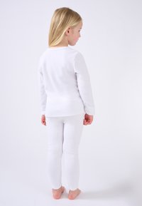 Set per bambini composto da una maglietta a maniche lunghe e leggings, realizzato in cotone, design aderente, con cuciture minime, semplice e senza motivi o accenti.