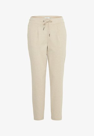 Bežové jogger kalhoty vyrobené z měkké látky, se stahovací šňůrkou v pase, bočními kapsami, zúženými nohavicemi a hladkou texturou.