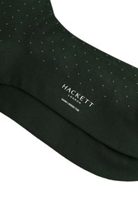Ciemnozielone skarpetki z małymi białymi kropeczkami. Zawierają logo "HACKETT LONDON" oraz napis "HAND LINKED TOE" nadrukowany na tkaninie. Miękka tekstura.