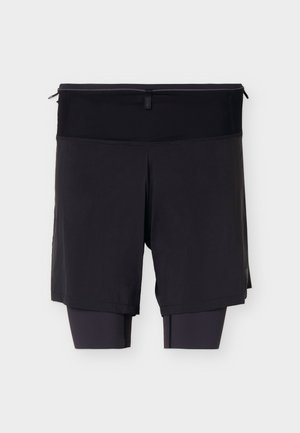 Shorts de sport noirs avec des leggings de compression intégrés et une taille haute avec une petite poche zippée à l'arrière.