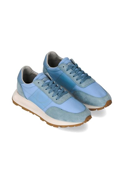 Blue sneakers made of suede and synthetic materials, featuring a rounded toe, rubber sole, and textured lace-up design.