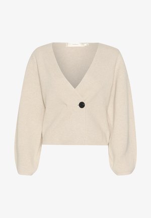 Béžový krátky kardigán z textúrovanej pleteniny. Obsahuje hlboký V-výstrih, dlhé nafúknuté rukávy a čierne gombíkové zapínanie.