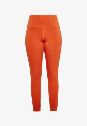 Lyse orange leggings med høj talje, lavet af glat, strækbart stof. Har sømfrie detaljer og en tætsiddende pasform.