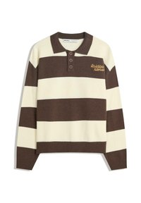 Hosszú ujjas póló pulóver széles vízszintes barna és krémszínű csíkokkal, három barna gombbal és sárga "laza történetek" felirattal a mellrészen.