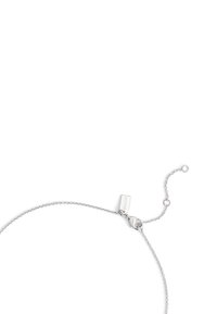 Bracelet en argent sterling avec un design de chaîne délicat, comportant un fermoir ajustable et un détail en forme de tag rectangulaire pour l'identification de la marque.